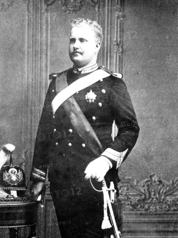 Late King of Portugal as young man, standing in uniforn