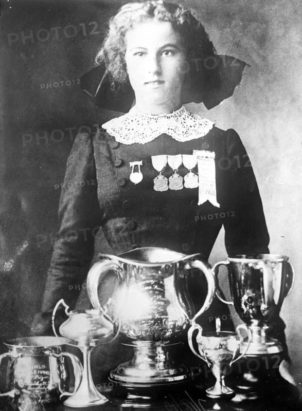 Alsie Aykroyd in front of her trophies 7 13 1910