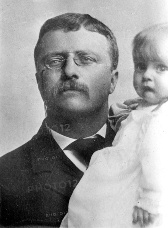 Theodore Roosevelt, holding child
