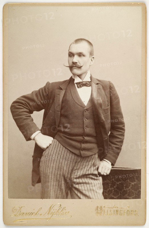 Photography studio portrait of Axel Gallén, leaning