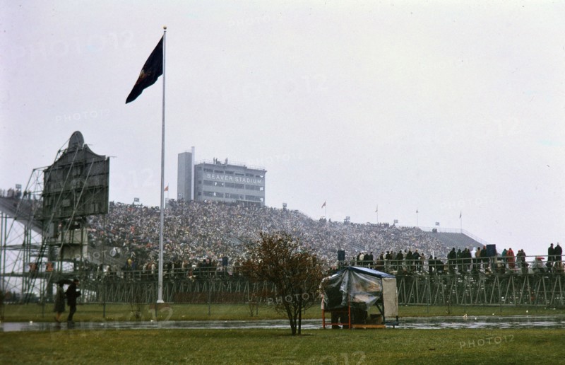 View of crowd in stands and parked cars at Beaver Stadium for Penn State football game (December 1962)