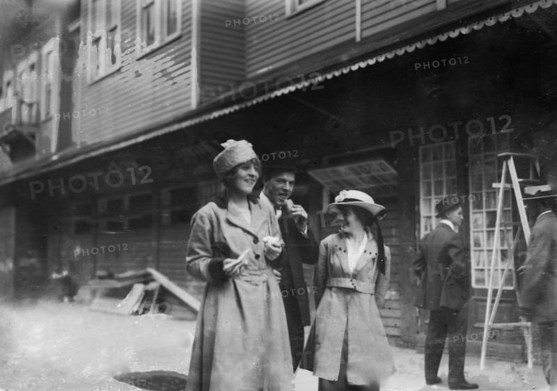 Coney Island vistors eating a hot dog ca. 1915