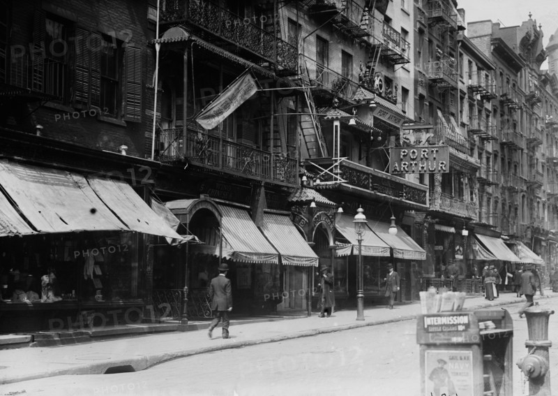 Mott Street in Chinatown, New York City. Church of the Transfiguration in the background and the Port Arthur restaurant at 7-9 Mott Street ca. 1910-1915