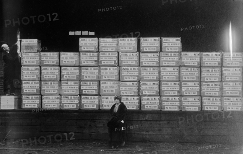 Mrs. George Washington-Lopp (Clara Dolores Machain) sitting in front of a shipment of cigarettes and cigars she arranged to have shipped to soldiers fighting in World War I ca. 1914-1915