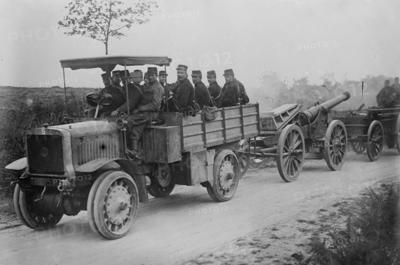 French soldiers in motor tractor which is pulling a large gun along the road at the beginning of World War I ca. 1914-1915