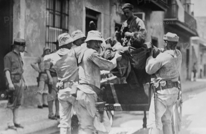 Vera Cruz -- putting dead Mexican in dump cart during the US occupation of Vera Cruz ca. 1914