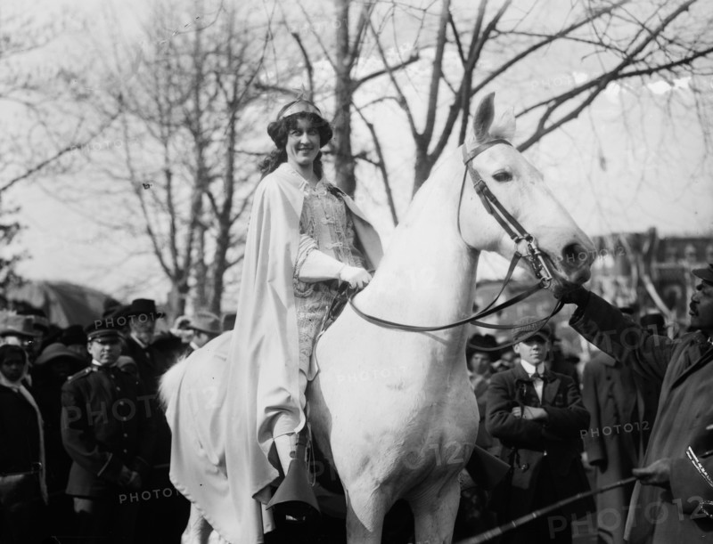 Inez Milholland Boissevain, wearing white cape, seated on white horse at the National American Woman Suffrage Association parade, March 3, 1913