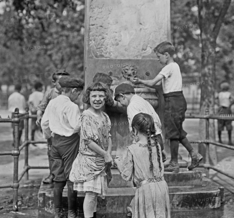 Children cooling themselves off in a fountain on a hot summer day in New York City ca. 1910-1915