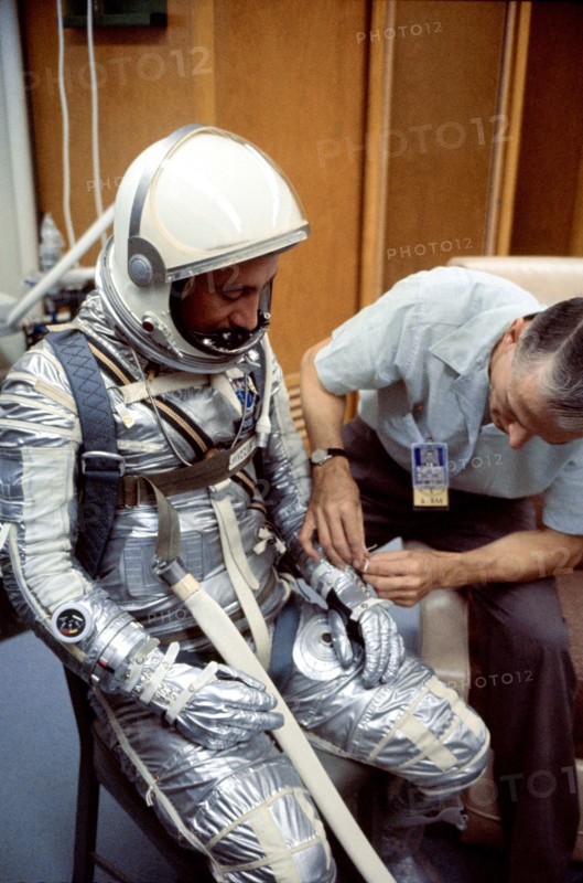 (1961) A NASA suit technician adjusts astronaut Virgil I. (Gus) Grissom's Mercury pressure suit during prelaunch activities at the Florida Space Center.