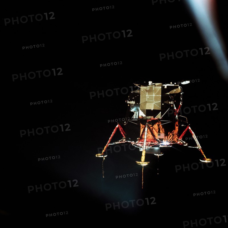 (20 July 1969) The Apollo 11 Lunar Module (LM), in a lunar landing configuration, is photographed in lunar orbit from the Command and Service Modules (CSM).