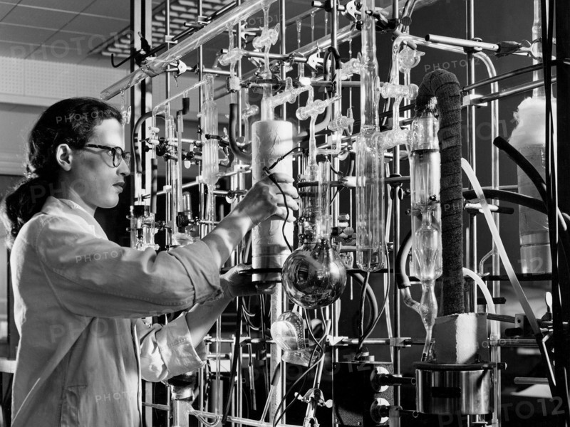 A materials researcher at the NACA’s Lewis Flight Propulsion Laboratory examines a surface crack detection apparatus in the Materials and Stresses Building during December 1952.