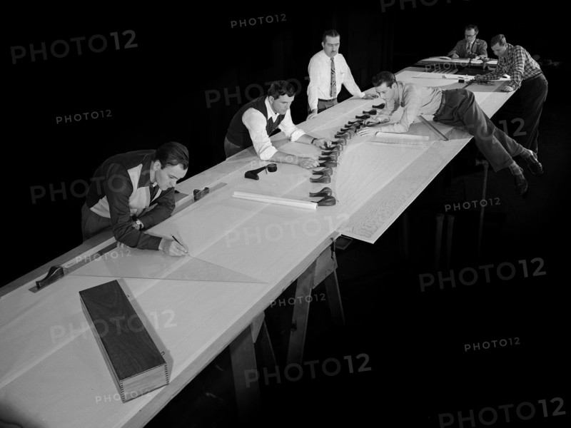 Draftsmen in the Materials and Stresses Building at the National Advisory Committee for Aeronautics (NACA) Lewis Flight Propulsion Laboratory create a template for a compressor using actual compressor blades. ca. 1953