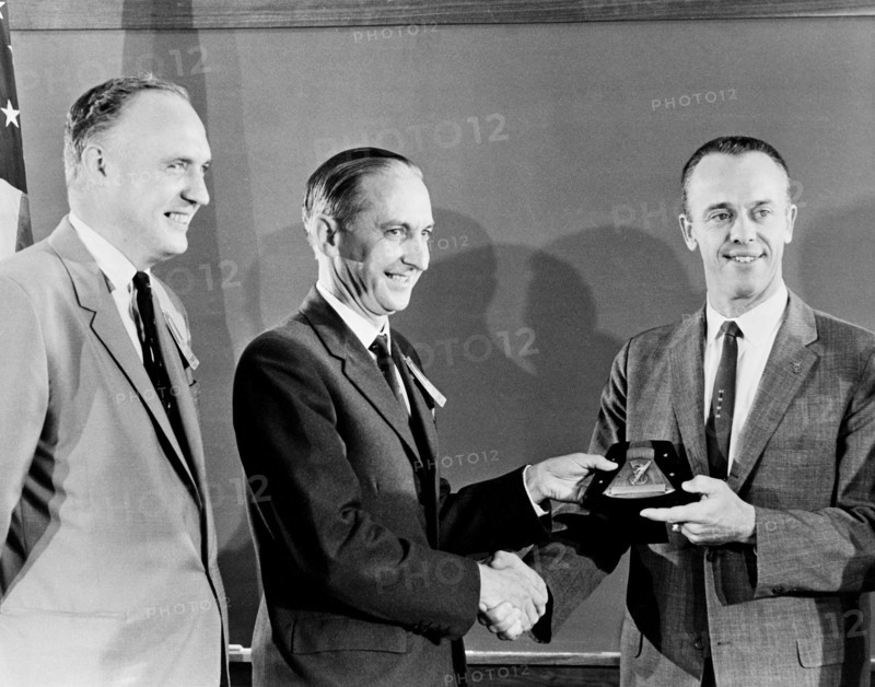 (1 Oct. 1961) Astronaut Alan B. Shepard Jr. (right) receives a plaque and award from members of the British Rocket Society.