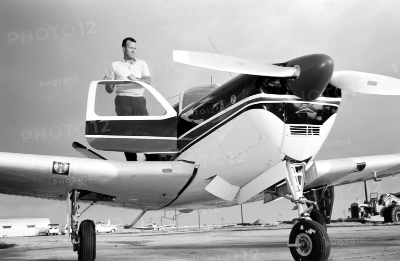 (1963) Astronaut L. Gordon Cooper Jr., prime pilot for the Mercury Atlas 9 (MA-9) 22-orbit flight, stands by his privately owned Beechcraft Bonanza aircraft, at Patrick Air Base, Florida.