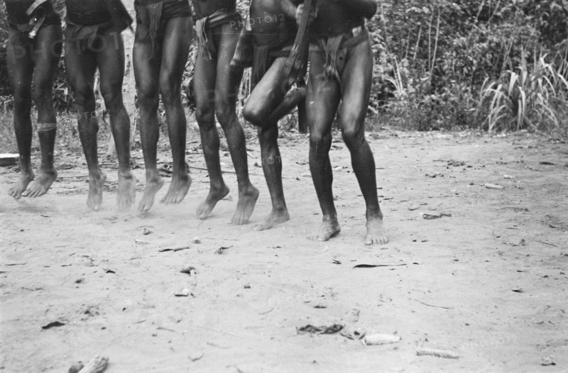 Papuans armed with guns do a war dance; Date November 10, 1947; Location Indonesia, Dutch East Indies