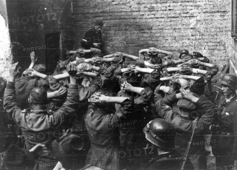 Warsaw Uprising: German POW’s taken in PAST-a building in a courtyard of a townhouse on Zielna street ca. August 1944