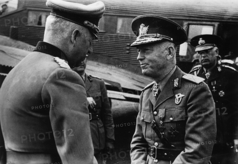 Marshal Erich von Manstein, German commander of the Wehrmacht, Nazi Germany's armed forces during the Second World War (left) welcomes Marshal Ion Antonescu to the field airfield. In the background, a visible fragment of the Junkers Ju-52 transport aircra