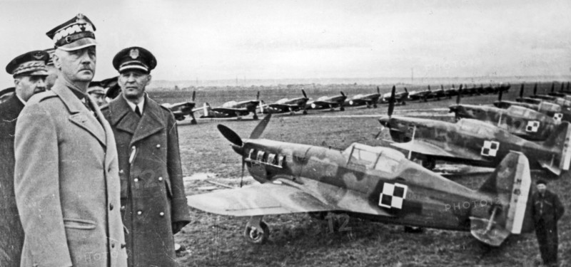 General Wladyslaw Sikorski's visit to the Polish Air Force training center in Bron - preparation for the parade. From the right: General Józef Zajac, General, Wladyslaw Sikorski, General Victor Denain. Morane Saulnier MS 406 fighter aircraft are als