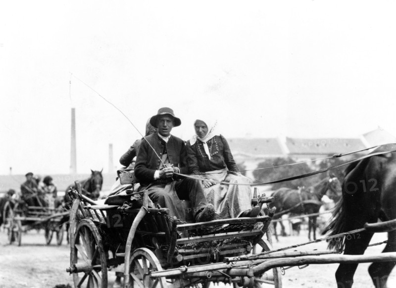 Man and woman on horse-drawn wagon, returning from market, Hungary 1923