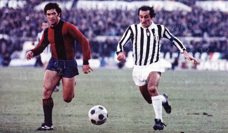 Franco Nanni from Bologna (left) and Giuseppe Furino from Juventus (right) chase the ball during a match between Bologna and Juventus ca. 1975-1978