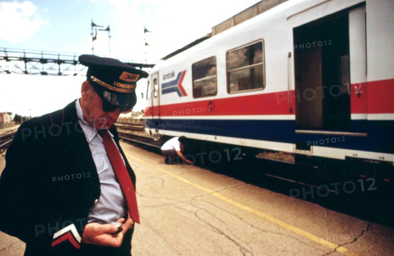 Conductor checks his watch, Bloomington, Illinois, stop on the turboliner run between St. Louis, Missouri, and Chicago, June 1974