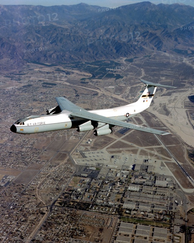 An air-to-air left side view of a C-141 Starlifter aircraft