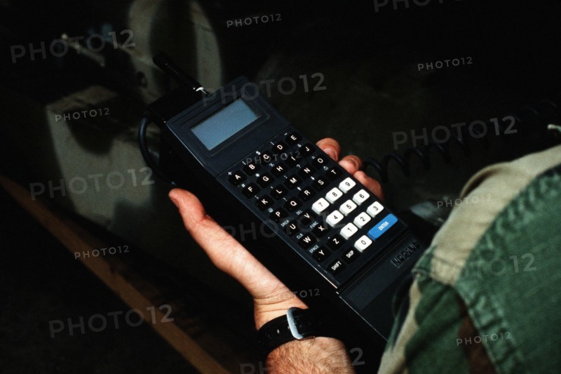 A Marine holds a small computer