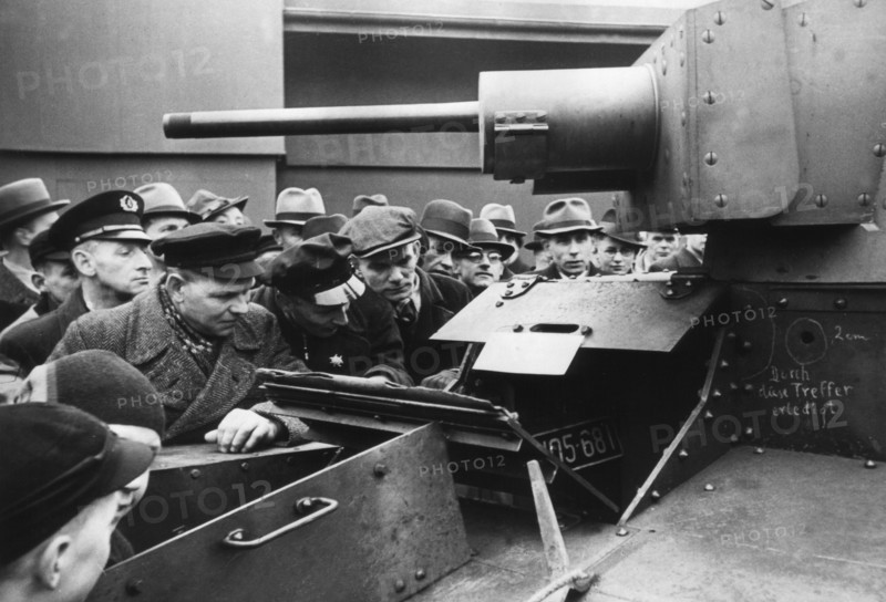 A group of Germans is watching a captured Polish 7TP tank exhibited at the Leipzig Fair. The hole described in chalk after being hit by a 20 mm bullet is visible ca. 1939
