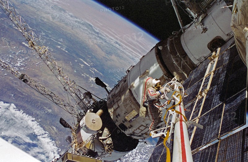 Cosmonaut Vasili V. Tsibliyev, Mir-23 commander, operates at the end of the Russian Mir Space Stations STRELA boom during a space walk on April 29, 1997