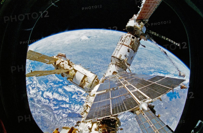 View of Mir Space Station as seen from flight deck overhead window and Spacehab