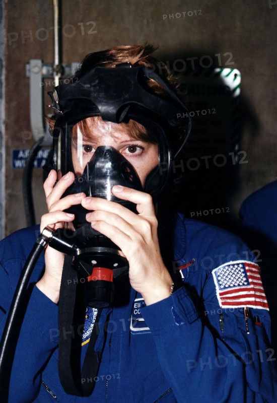 STS-84 Pilot Eileen Marie Collins practices using a gas mask during Terminal Countdown Demonstration Test (TCDT) activities at Launch Pad 39A ca. 1997