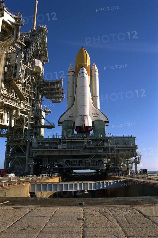 Atop the crawler/transporter, the Space Shuttle orbiter Atlantis rolls out to Launch Complex 39A in preparation for mission STS-86 ca. 1997