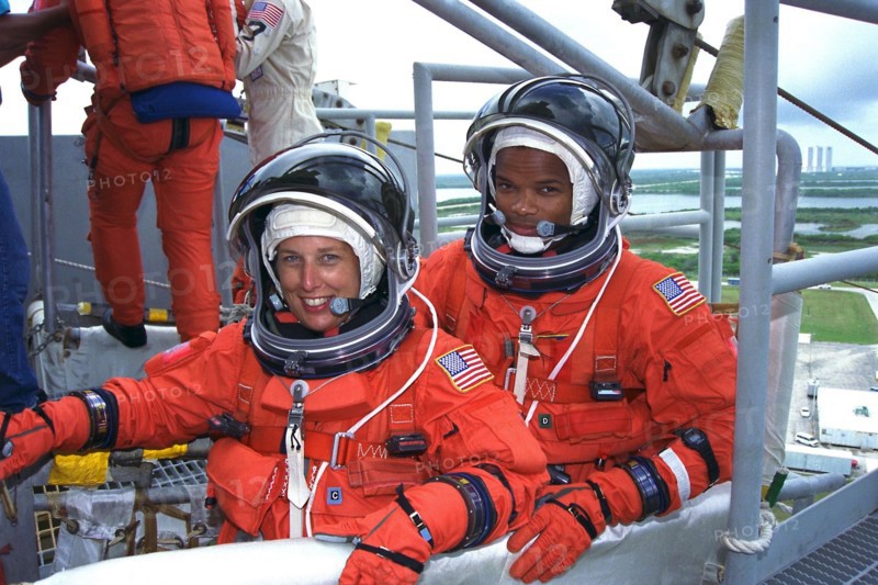 STS-85 Payload Commander N. Jan Davis (left) and Mission Specialist Robert Curbeam, Jr., check out an emergency egress slidewire basket at the 195-foot level of Launch Pad 39A during Terminal Countdown Demonstration Test (TCDT) activities ca. 1997
