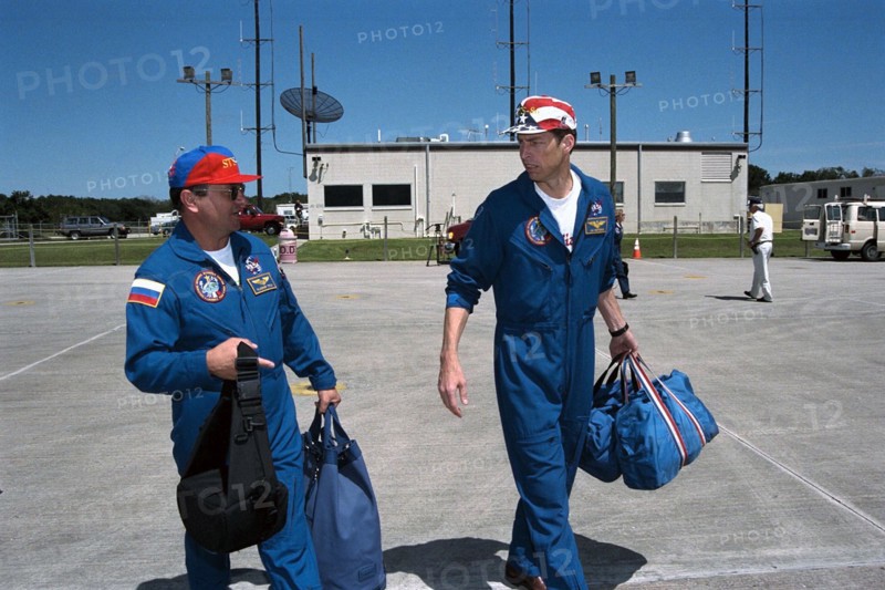 STS-86 Commander James D. Wetherbee, at right, and Mission Specialist Vladimir Georgievich Titov prepare to leave from KSC’s Shuttle Landing Facility ca. 1997