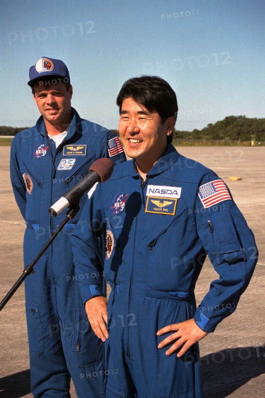 Takao Doi speaking at a microphone after arriving at Kennedy Space Center ca. 1997