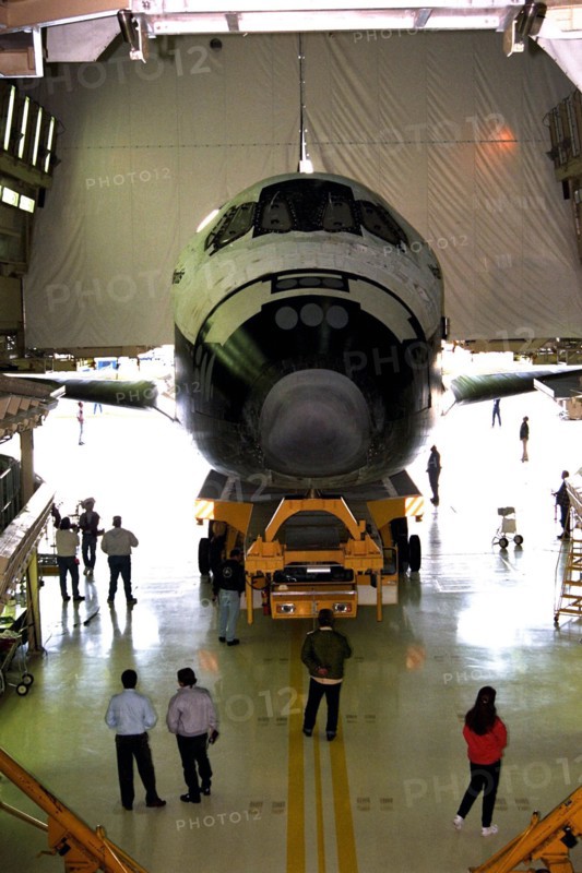 The orbiter Atlantis rolls out of the Orbiter Processing Facility at Kennedy Space Center (KSC) for its journey to the Shuttle Landing Facility ca. 1997