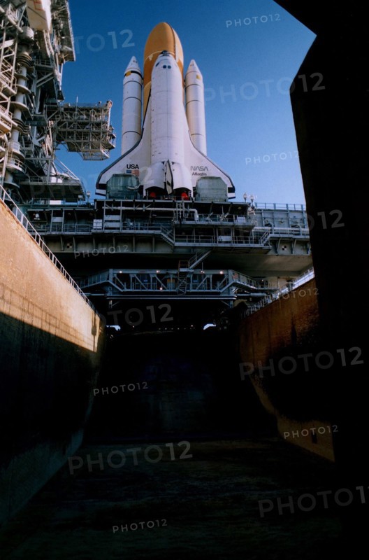 The Space Shuttle Atlantis sits majestically atop its Mobile Launcher Platform and a Crawler-Transporter which straddle the Launch Pad 39A flame trench ca. 1997