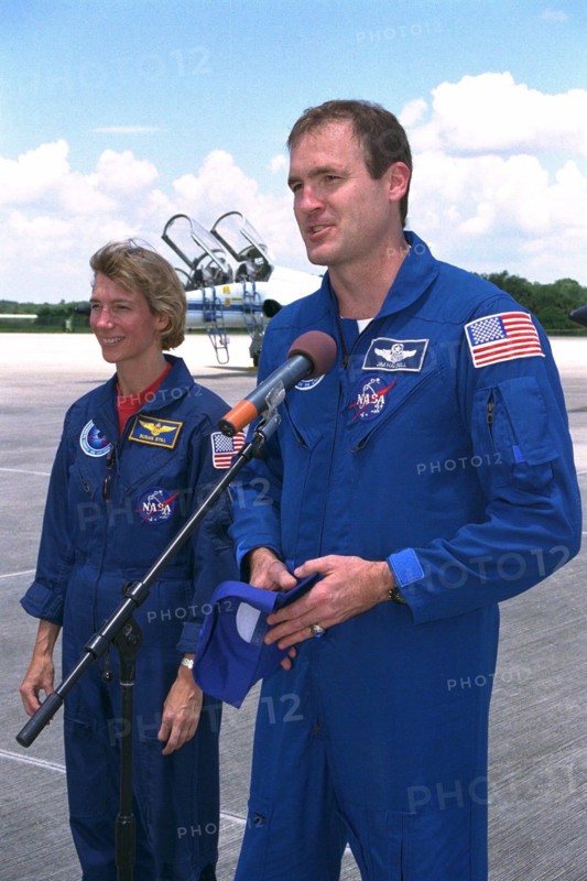 STS-94 Pilot Susan Leigh Still watches as Commander James D. Halsell, Jr., speaks to the media after the crew arrived at the Shuttle Landing Facility at Kennedy Space Center  ca. 1997
