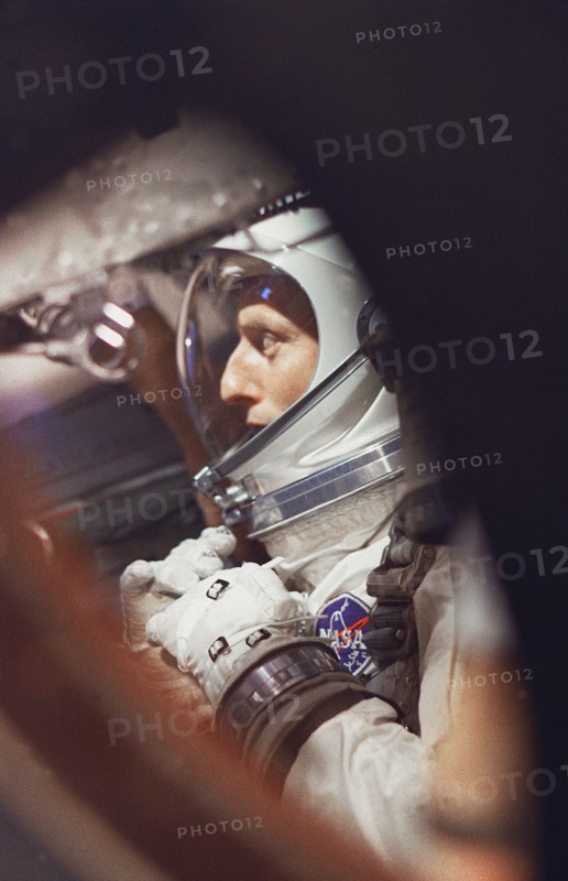 (21 Aug. 1965) --- View of astronaut Charles Conrad Jr. through the window as he sits in the Gemini-5 spacecraft during preflight activities