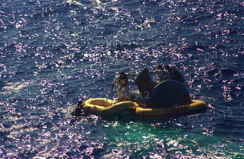 (29 Aug. 1965) - Astronauts L. Gordon Cooper Jr. and Charles Conrad Jr. exit their spacecraft after splashdown of the Gemini-5 spacecraft