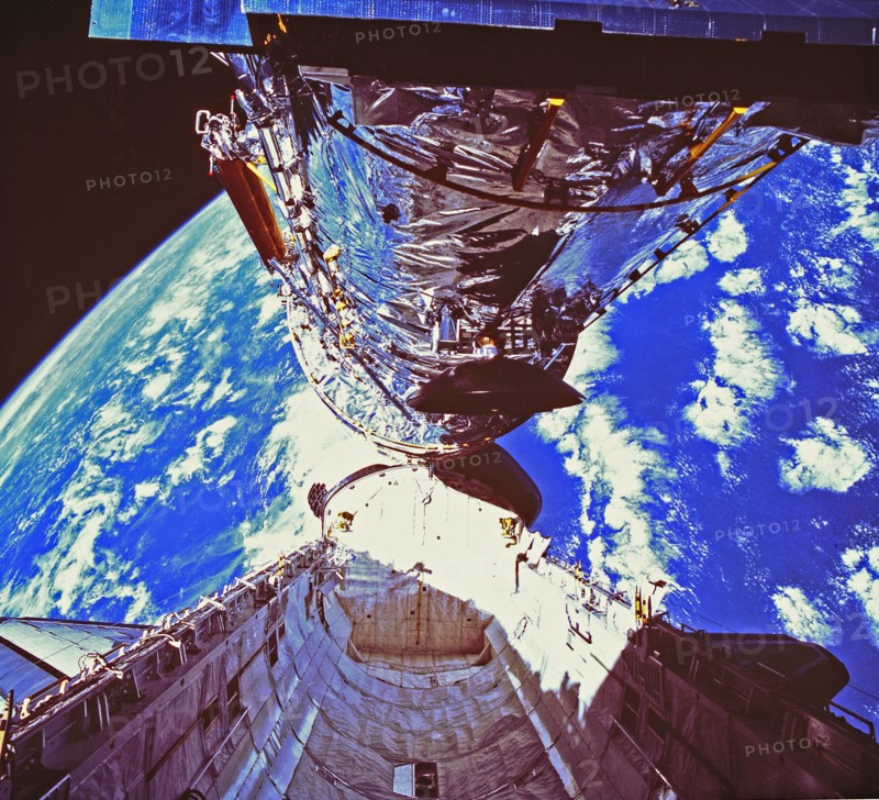 In this photograph, the Hubble Space Telescope (HST) is clearing the cargo bay during its deployment on April 25, 1990. The photograph was taken by the IMAX Cargo Bay Camera (ICBC) mounted in a container on the port side of the Space Shuttle orbiter Disco