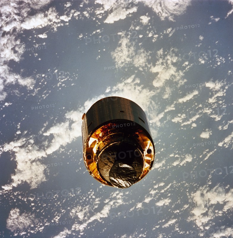 1992 - The 4.5 ton satellite was successfully snared by three astronauts on a third EVA. The three hand-grabbed the errant satellite, pulled it into the cargo bay, and attached a boost-given perigee stage before its release. In this photo, the satellite s