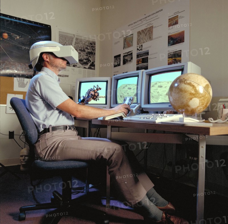 1992 - Virtual Environment Telepresence workstation, simulated Mars Exploration shows Lewis Hitchner with virtual helmet and EXOS Dexterous interface (virtual hand)