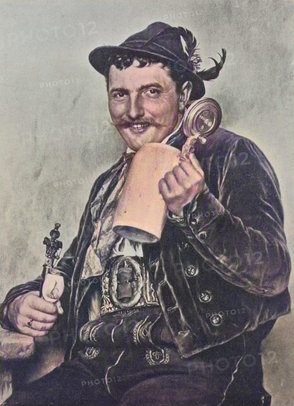 Bavarian man wearing traditional dress and holding a beer mug and a pipe