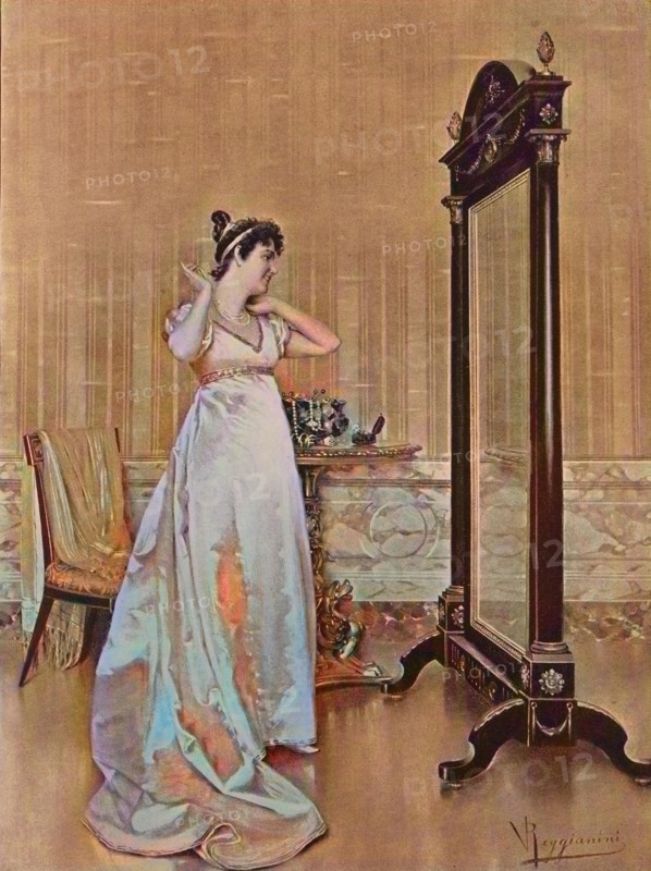Woman tries a new necklace at home in front of the mirror