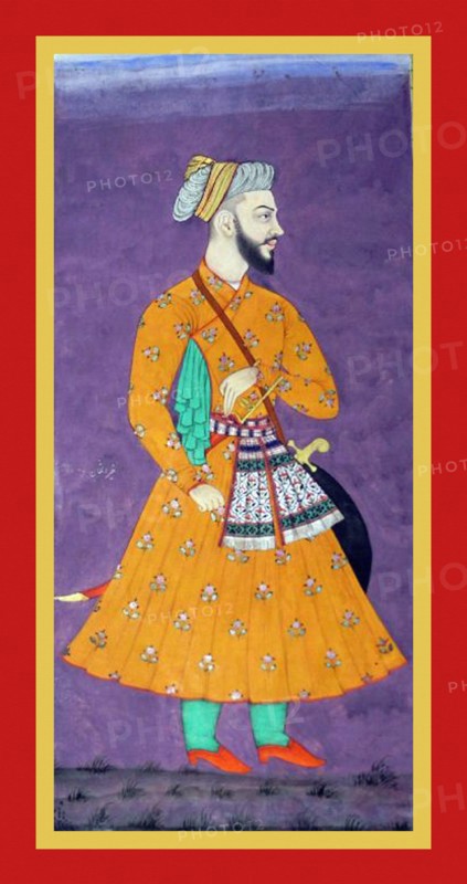 Khairat khan stands in a  flower-patterned orange tunic