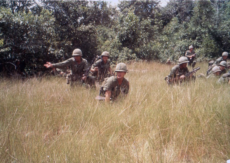 US 14th Infantry Division draws Viet Cong sniper fire while on a search mission. Vietnam, 1965.