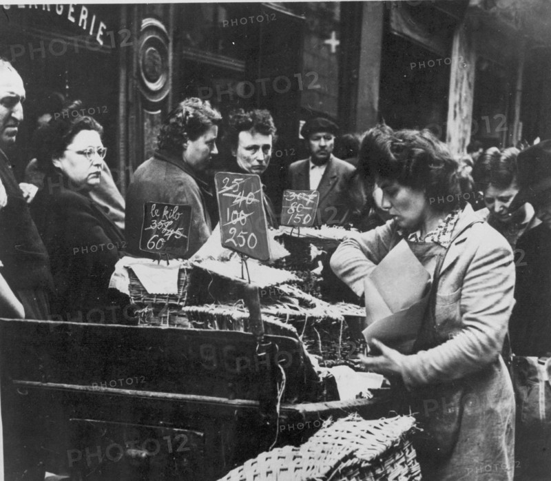 Somber French shoppers see the result of rampant inflation in the rising prices of consumer goods, France, circa 1947.