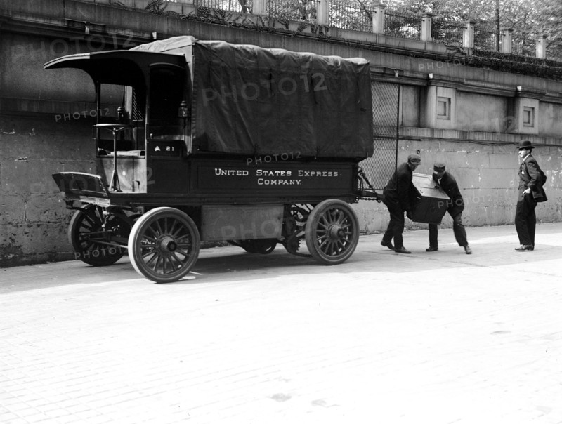 Workers loading a trunk onto a United States Express Company truck ca. 1913-1917