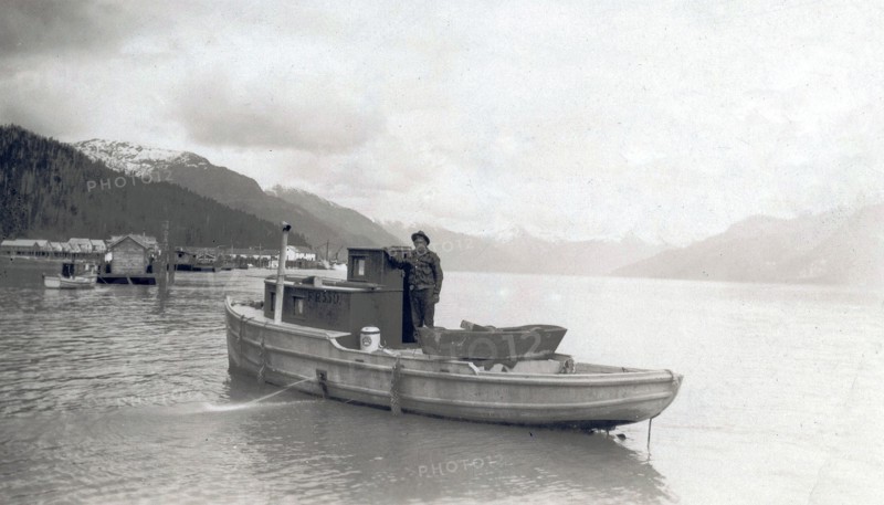 Title: View of Emil Colman aboard his boat on the Skeena River